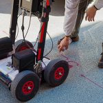 Utility locating services are a necessary step when preparing for any construction project, because they make construction safer and more efficient. Ground penetrating radar is a highly effective method that lets you know about any features below ground, from utility lines to septic tanks. It's always better to learn about your building site before getting a project started, to prevent any potential issues. With the help of ground penetrating radar, construction teams can prepare for underground obstacles and avoid costly mistakes. What Is GPR? Ground penetrating radar is a non-destructive method for getting images of anything beneath the ground, including voids. It uses radio waves to indicate the locations of objects below the surface. It has a wide variety of applications, including scientific studies, archaeology, and of course, construction. GPR technology functions by sending radar signals in the direction of a target area, which tells you if there's anything present there. A GRP system will interpret the reflected signals and assemble the data into an image of the object. When a survey is complete, you'll learn the exact locations of the utility lines and be made aware of any other subsurface features. How Does GPR Work? GPR works by using radio waves to locate objects underground. It transmits pulses of energy with a frequency range up to 1000 MHz. When those energy pulses are directed into the ground, objects below the surface reflect that energy and show up on the radar. All GPR systems are equipped with a receiver antenna, to record the reflected waves. Software assembles those reflected GPR signals into a visual, and the results show the size and shape of any object below ground. Each energy pulse returns more data to the receiver about the location and material properties of any items below. GPR equipment uses different frequencies to collect information about various depths and provide different resolution levels. With the help of GPR data, you can learn which areas contain utility lines or other potential obstacles. This method of data collection can detect all kinds of materials, including metal, rock, and PVC. Utility locating experts often start in areas marked for utility lines, but sometimes utility lines aren't where they should be. Other areas of interest include those with distinguishing features like valves. Once surveyors locate an object, they'll cover the area with the GPR cart or radar antenna more than once to get more details on the dimensions and depth of the item. GPR is a cost-effective way to survey an area before building on it, and it will keep you alert to any potential surprises, ranging from unauthorized utility lines to changes in soil composition. Advantages of a Ground Penetrating Radar GPRs provide plenty of advantages, and it's very useful as a non-destructive method of surveying an area before any excavation or building starts. A professional survey from a GPR device arms you with the information you need to make good decisions for your construction site. Here are some of the ways you can benefit from using a GPR on construction projects. 1. Provide a Starting Point The best time to get a GPR survey done is before you even start your project. If you ascertain the locations of underground utilities before you start to build, the process can go much more smoothly. Once you know where important utility lines are located, it's easier to build the rest of the structure around them. In some cases, utility lines may need to be moved before you can complete a construction project. 2. Keep Your Team Members Safe Underground utilities like pipes and wires are potentially dangerous. Cut power lines can electrocute people, and gas lines can cause explosions. The GPR results for your construction site will let you know the exact location of utility lines so you can avoid any unfortunate surprises. You can prioritize safety for your team members by getting professional utility locating services. 3. Avoid Costly Damage Not only are utility lines dangerous, they can also cause significant damage to your site or building materials. Explosions, fires, and floods from cut utility lines can result in a lot of damage to building materials and equipment. Damage prevention is always cheaper than repairs or replacements, so invest in a GPR survey before construction begins. 4. Get More Accurate Results Utility mark outs are made with the best of intentions, but they aren't always accurate. Sometimes they're made using old, out of date records. Instead of relying on provided records, play it safe and get professional utility locating. GPR lets you find the location of any utilities easily and with a 97% accuracy rate up to a depth of 13 feet. This survey method tells you the specific locations of important utility lines. It can even detect a wide range of materials, not just conductive metals. Professional utility locators can also adjust the antenna frequency to detect items at different depths. High frequency radio waves provide higher resolution, giving you the most accurate reading of subterranean obstacles. 5. Discover Potential Obstacles During utility location, people normally have an idea of what to expect and what to look for, like gas and power lines. However, some obstacles might not show up on records, either because they're naturally occurring or they were done unofficially. Without GPR survey, concrete structures and abandoned lines could take you by surprise. Items like tree roots or buried objects can get in the way of your building project, but a GPR technician will alert you to these obstacles before they become a serious problem. GPR systems even let you know about the soil conditions of the building site! How Effective Is GPR? GPR is a useful tool in an arsenal dedicated to figuring out subterranean conditions and obstacles. It's an important part of any construction site preparation. This survey method has an incredible 97% accuracy rate with a penetration depth of 13 feet. What's more, GPR procedures are low-cost, work quickly, and are great for locating important structures below ground without disturbing the soil. It's the best technology available for surveying a site, and it can save you a lot of money by preventing expensive problems. Before you start a project that involves digging into the ground, get professional utility locating services first. Util-Locate uses cutting-edge technology to provide fast and accurate readings for utility line locations. Contact us today to learn more about our services or to schedule an appointment.